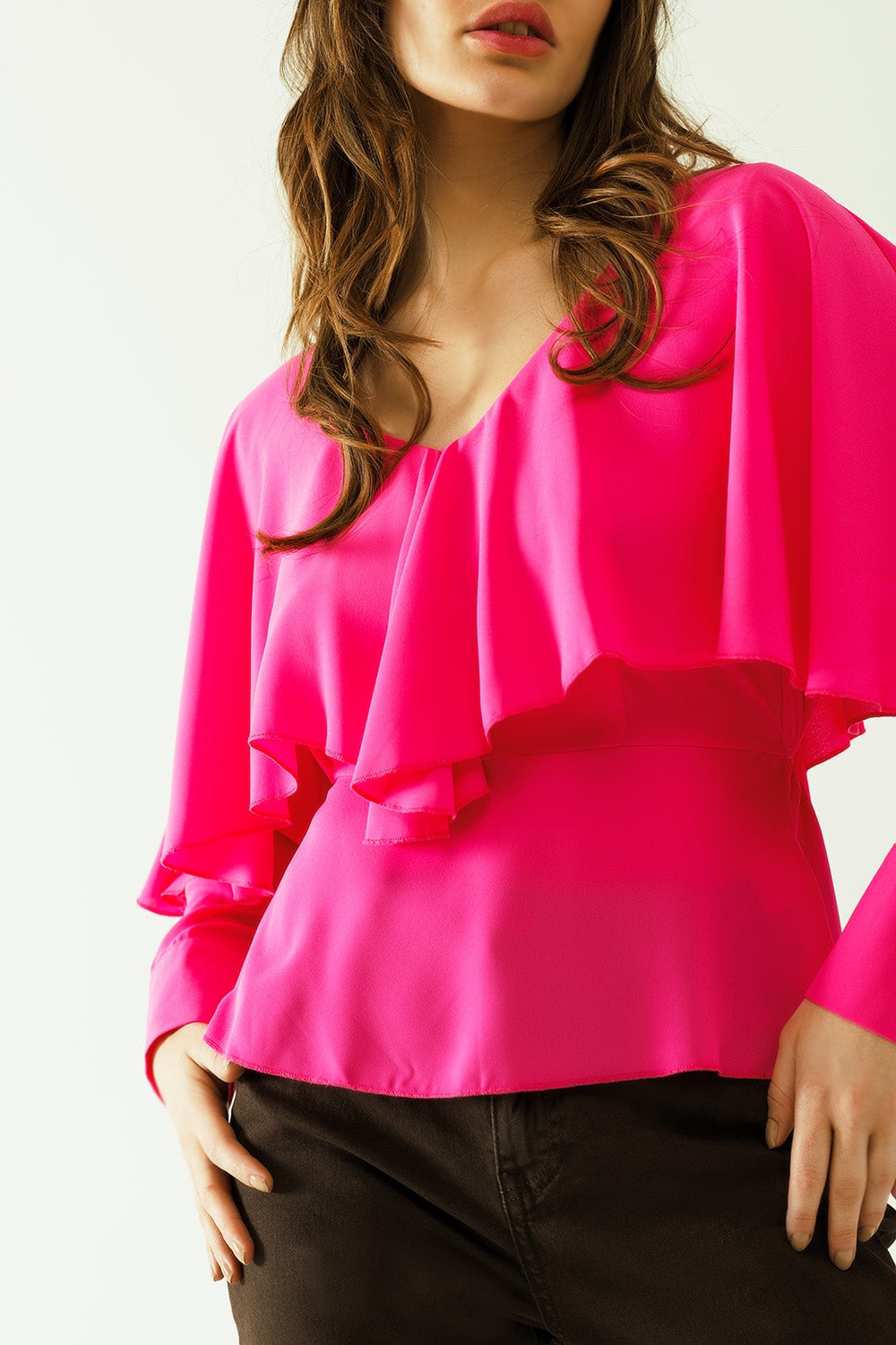 Ruffled V-neck top with buttoned cuffs and tie in the back detal in fuchsia