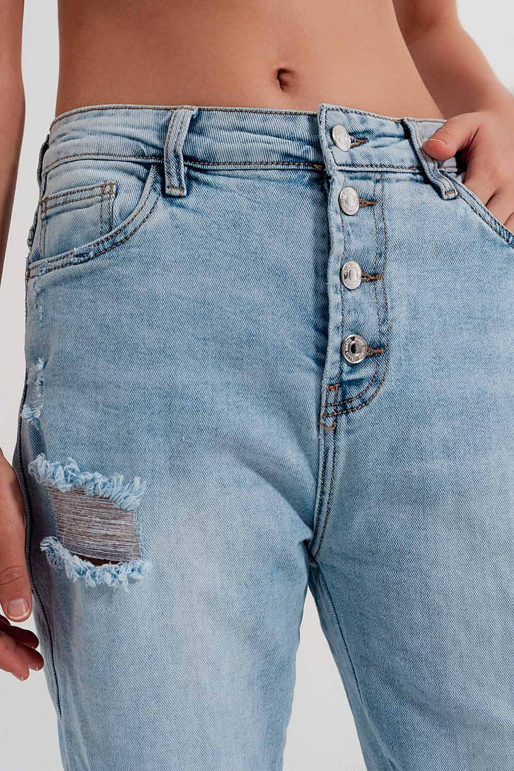 Straight leg distressed jeans with button detail in light blue