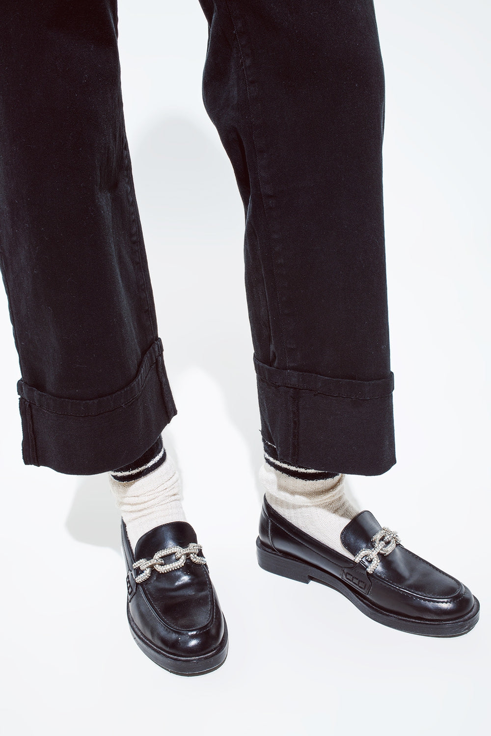 Straight leg jeans in black with folded trouser legs