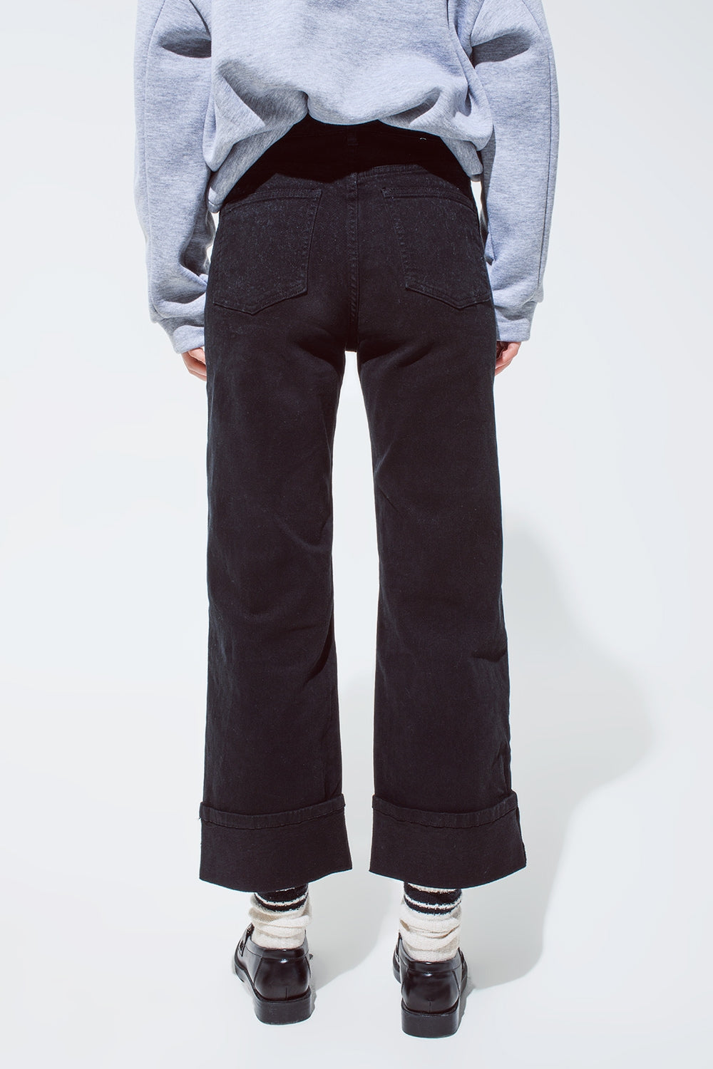 Straight leg jeans in black with folded trouser legs