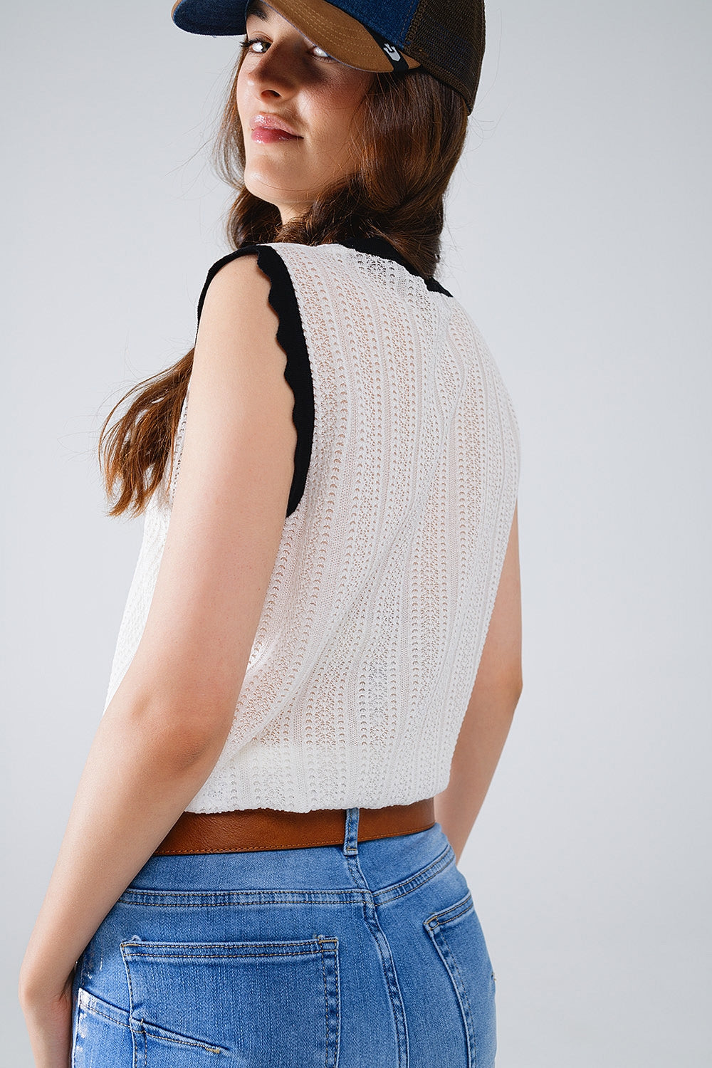 white knitted pointelle top with black wavy trim