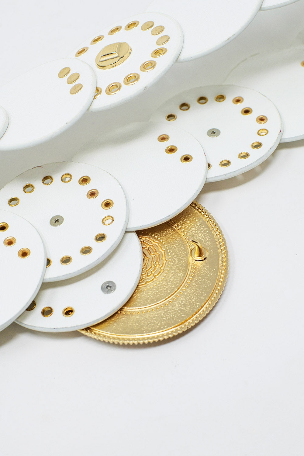 White leather belt with white rhinestone round buckle and golden details