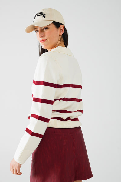 white sweater with dark red stripes and wide v neck