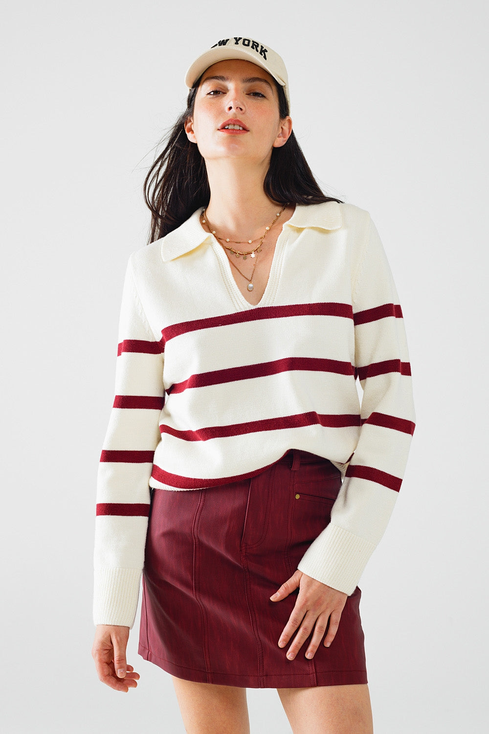 white sweater with dark red stripes and wide v neck