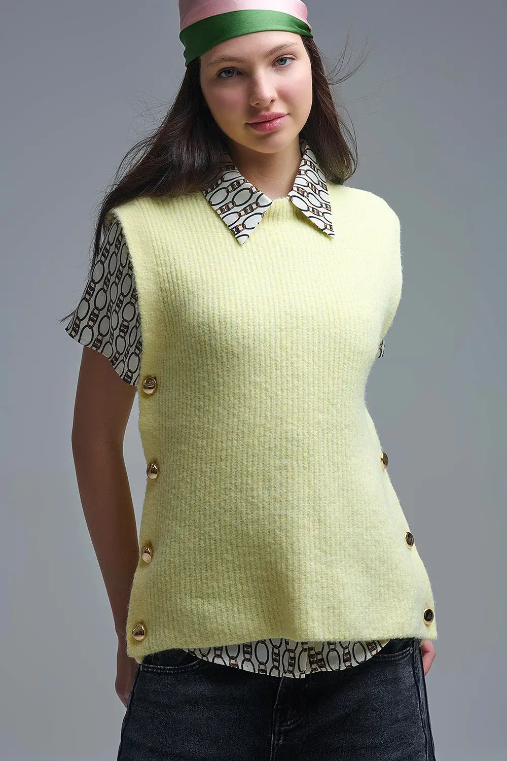 Q2 Yellow sleeveless sweater with gold buttons on side